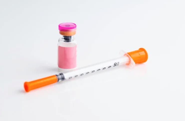 Pink peptide vial and insulin syringe for semaglutide injection
